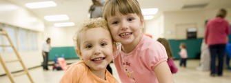 Two pre-school aged girls at community centre